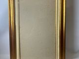 an old picture frame with a gold border and a white background