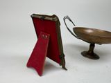 a small metal bowl with a red tag next to it
