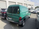 a green van that is parked in a parking lot