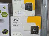 three boxes of tado products sit on a shelf in a store