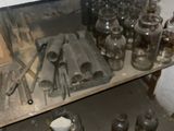 many jars and spoons sitting on a shelf in a kitchen