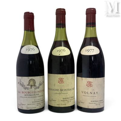 three bottles of wine are lined up on a white surface