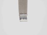 an image of a silver watch strap hanging from the side of a white wall