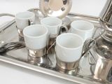 a silver tray with cups and a teapot on it