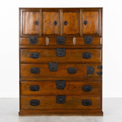 an old wooden chest of drawers with many drawers on top