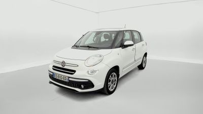 Une petite voiture blanche est garée dans une pièce blanche.