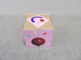 a pink box with a picture of a cherry on it