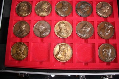 a red case with a lot of coins in it