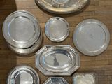 beaucoup d'assiettes en argent posées les unes à côté des autres sur le sol
