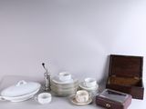 a lot of white dishes and cups on the table