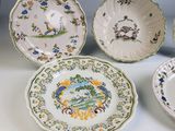 several plates with different designs are sitting on a table