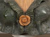 a sculpture of a busturine with a rose on it