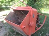 a red machine that is sitting in the grass