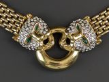 a close up of a necklace with two lions on it