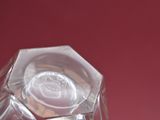 a glass vase with a flower inside of it