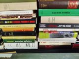 a lot of books that are stacked on top of each other