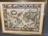 an old map of the world is displayed in a gold frame