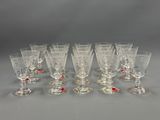 a set of twelve glass goblets with red and white designs