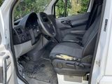 a white van with the door open and the driver ' s seat down
