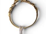 a close up of a gold ring with a blue stone on it