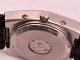 a close up of a watch on a white surface