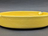 yellow bowl on grey background with black background