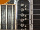 a close up of an electric guitar with a guitar pick up