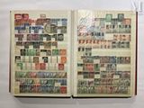 an open book with stamps on it on a table