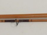 blurry photograph of a brush with a wooden handle on a white surface