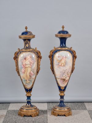 une paire de vases bleus et dorés posés sur un sol à carreaux