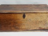 an old wooden box sitting on top of a white surface
