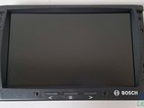 a close up of a small monitor on a white surface