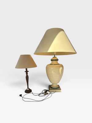 two lamps on a white surface with a light on top of them