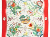 a close up of a red and white scarf with flowers and birds on it