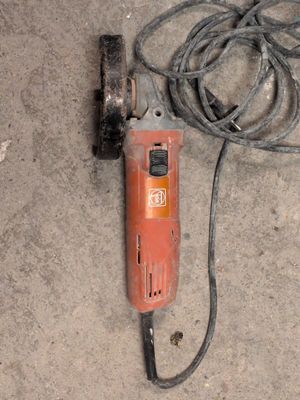 a cord and a drill on the ground