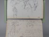 an old book with a drawing of people on it and a piece of paper with writing
