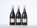 three bottles of wine sitting on top of a table