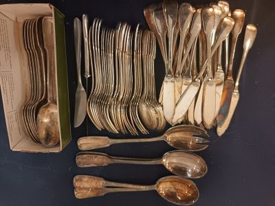 many spoons and forks in a box on the table