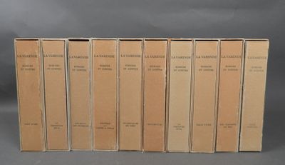 six books are lined up in a row on a gray surface