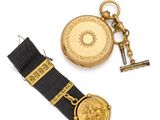 an image of a gold pocket watch and a gold keychain