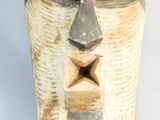 an image of a wooden sculpture of a face