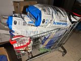 a shopping cart filled with bags of food and other items