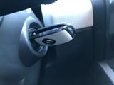 a close up of a car door handle with a cell phone in it