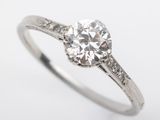 a close up of a diamond engagement ring on a white background