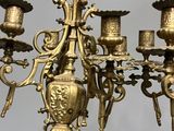 a gold colored candelab with five candles on it