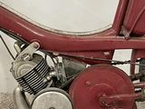 a red motorcycle with a red seat and a red handlebar