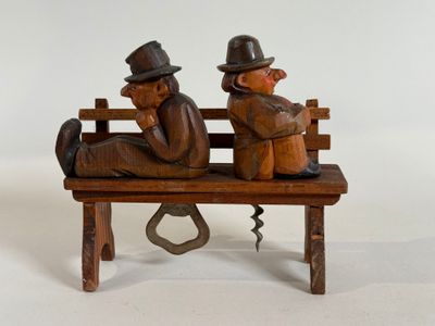 two figurines of two men sitting on a bench