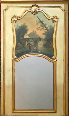 TRUMEAU en bois laqué et doré à décor sculpté de coquilles e…