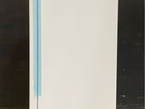 a white refrigerator with a blue handle sitting on a counter