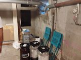 a man that is standing in a room with some kegs